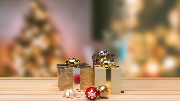 The Christmas balls and gift box on wood table for holiday concept