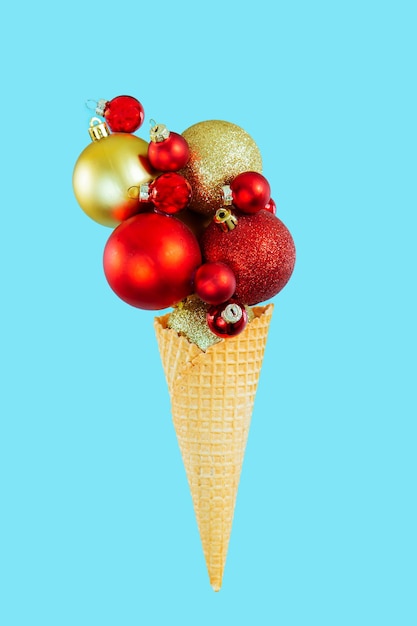 Christmas balls in a waffle cone on a blue background