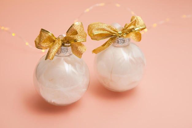 Christmas ballsModern set of glass decorations with white feathers New Year's Pearl pink gold