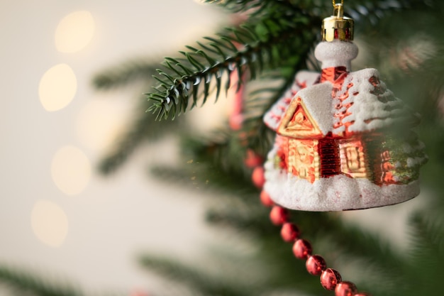 Christmas bauble on Christmas tree with lights bokeh background.