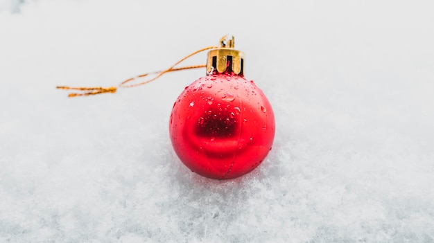 Christmas bauble in the snow single red bauble