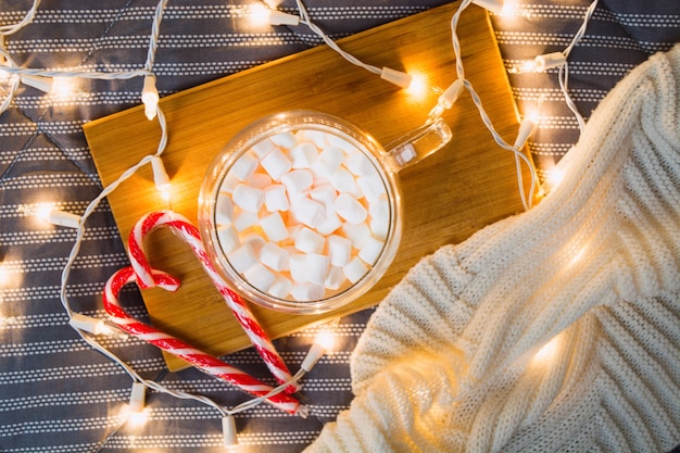 Christmas beautiful card with marshmallows and heart of candy canes