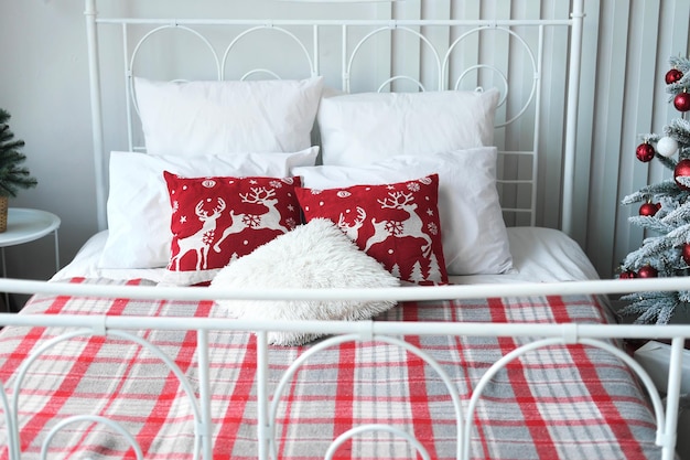 Christmas bedroom decor Christmas pillows and checkered blanket on double bed