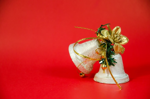 Christmas bell on red background