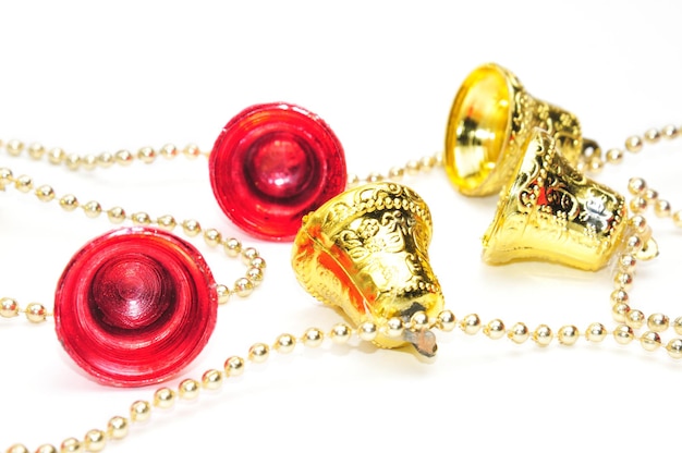 Christmas bells in red and gold color with chain on isolated white background