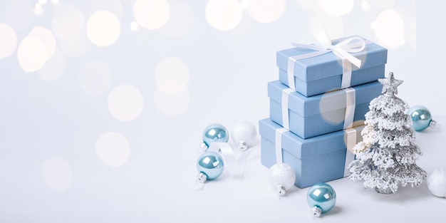 Christmas blue gifts with decorations on white background copy space