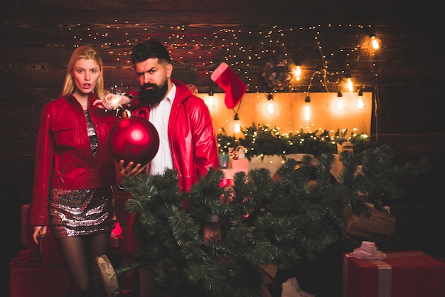 Christmas bomb Creative boom Couple in love Christmas interior Portrait of surprised and funny coupl