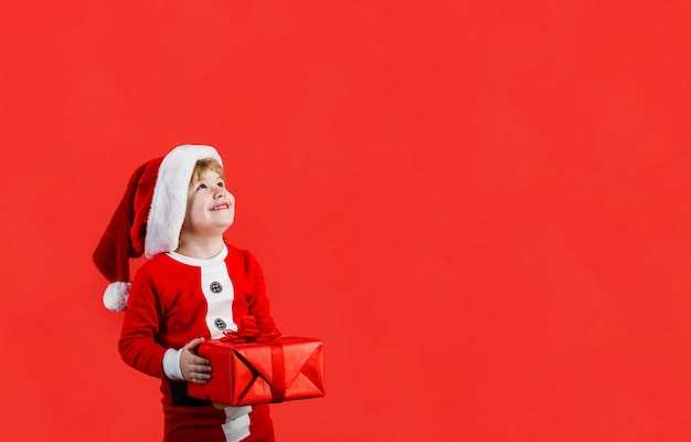 Christmas boy little kid celebrating christmas little boy with christmas present happy boy in santa