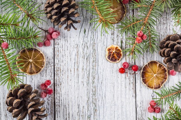 Christmas branches with cones viburnum berries and dry lemon slice