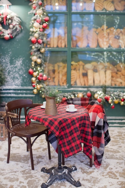 Christmas cafe bakery exterior with Christmas decorations and fresh bread in glass showcase