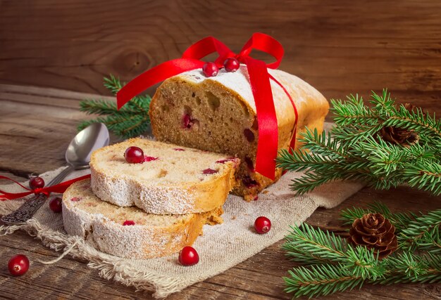 Christmas cake with cranberry on an old wooden background.