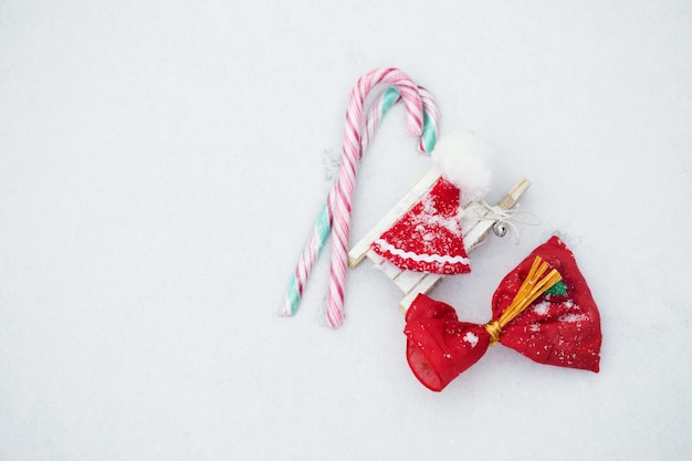 Christmas candies and mini Santa Claus hat. Flat lay