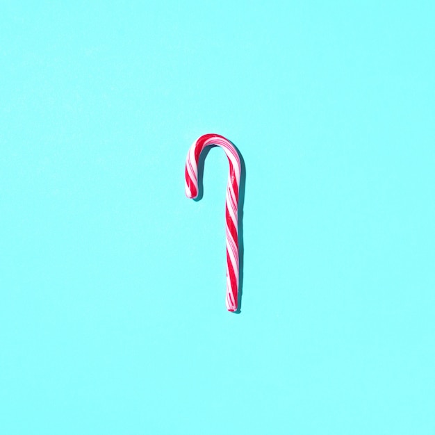 Christmas candy cane on blue background