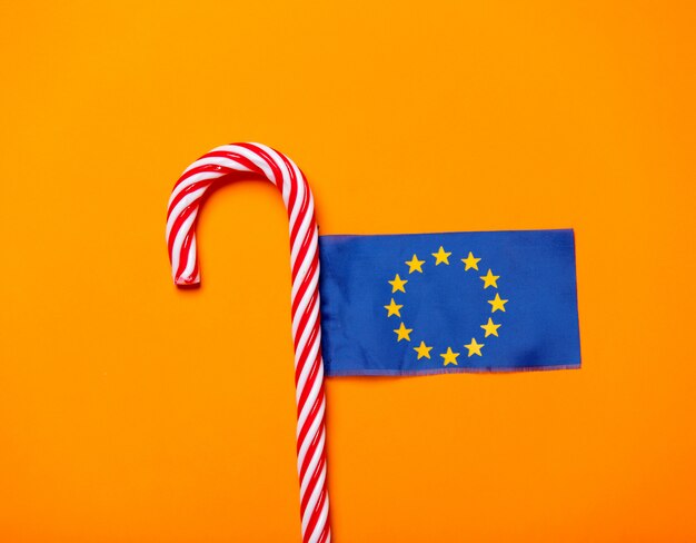 Christmas candy cane and flag of Europe Union