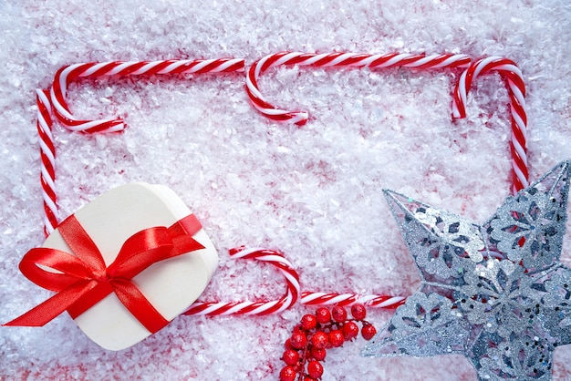 Christmas candy cane frame on snow