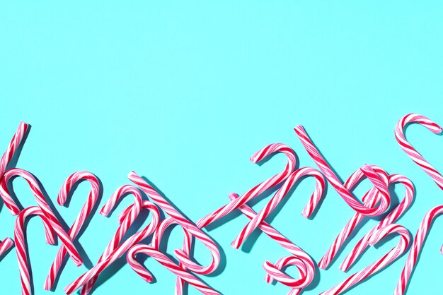 Christmas candy canes on blue background