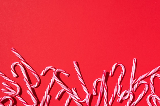 Christmas candy canes on red background