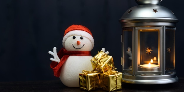 Christmas card a snowman a lantern with candles bright shiny boxes with gifts and blurry lights