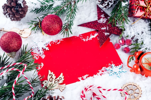 Christmas card with decorated fir tree on snow.