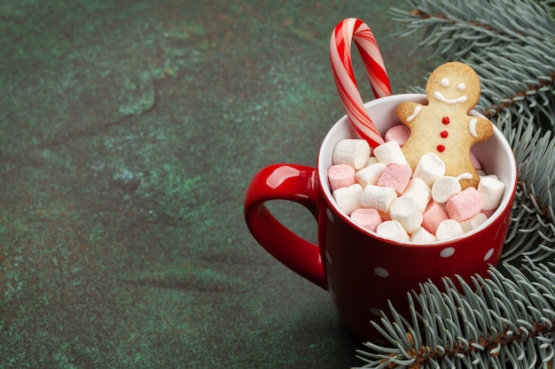 Christmas card with fir tree and cup with marshmallow