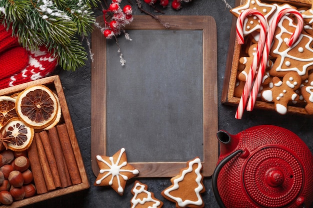 Christmas card with gingerbread cookies tea and fir tree