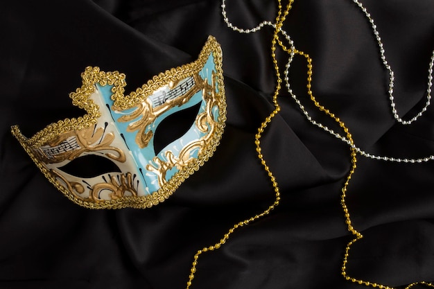 Christmas carnival mask on the on the black textile background Top view Closeup