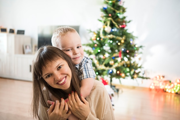 Christmas celebration Family in room with Christmas tree