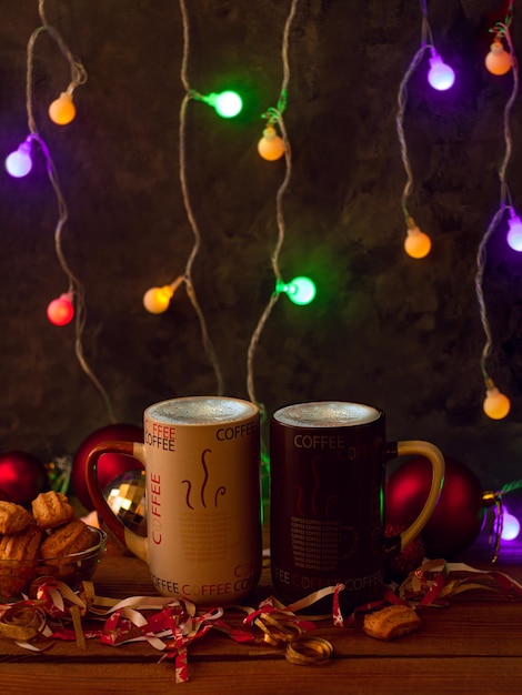 Christmas coffee cups with flickering bokeh lights decoration Winter holidays music background cozy home good morning