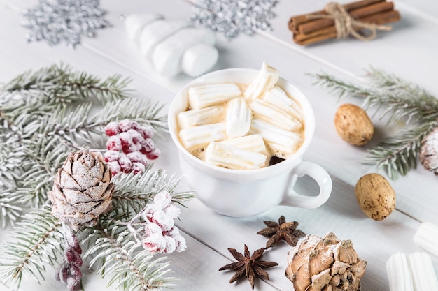 Christmas coffee with marshmallows and branches of spruce