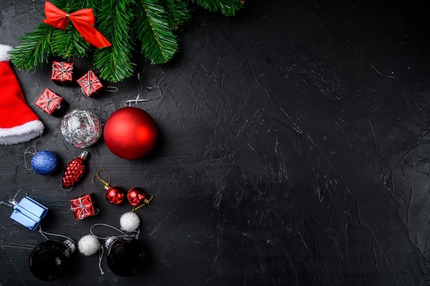 Christmas composition. Christmas gift, balls set, top view flat lay, on black dark stone table background, with copy space for text