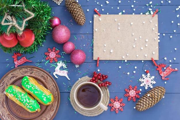 Christmas composition a cup of tea with a cake on a wooden background