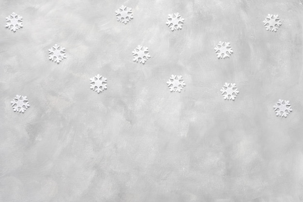 Christmas composition. Frame made of snowflakes on grey background. Flat lay, top view. Banner