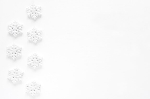 Christmas composition. Frame made of snowflakes on white background. Flat lay, top view. Banner