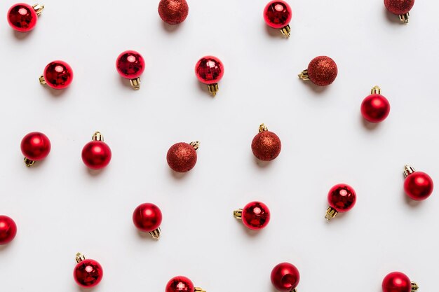 Christmas composition a pattern of christmas balls on colored background Flat lay top view New year decor