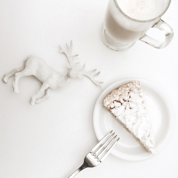 Christmas composition pie with cappuccino and figurine deer