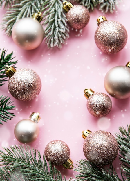 Christmas composition. Pink decorations on pastel pink background. Christmas, winter, new year concept. Flat lay, top view, copy space