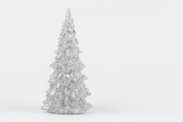 Christmas composition Silver Christmas tree on a silver background Happy Holidays