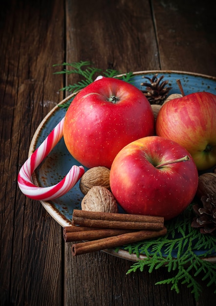 Christmas composition with apples, nuts and cinnamon