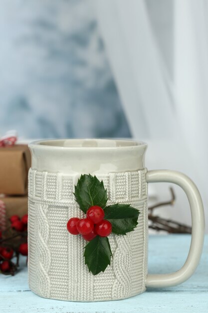 Christmas composition with cup of hot drink, on wooden table