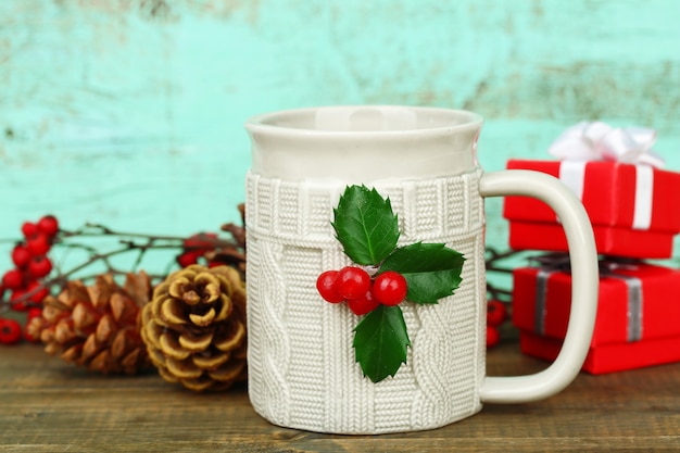 Christmas composition with cup of hot drink, on wooden table