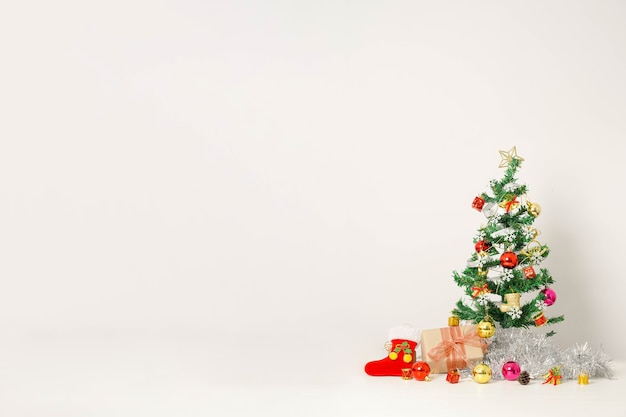 Christmas composition with decorations and gift box with bows on white