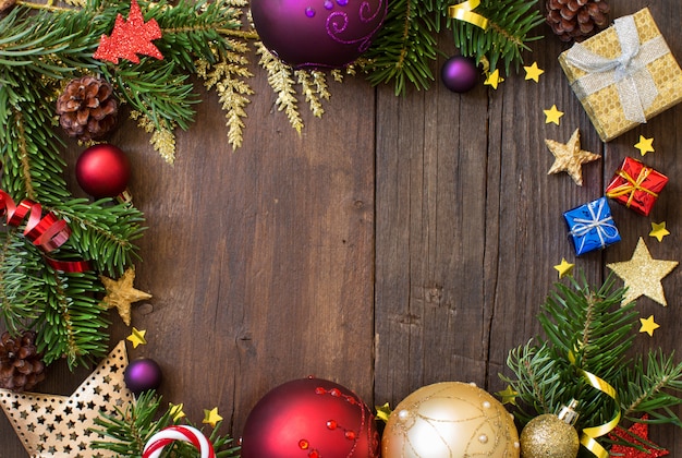 Christmas composition with decorations and paper on wood top view with copy space