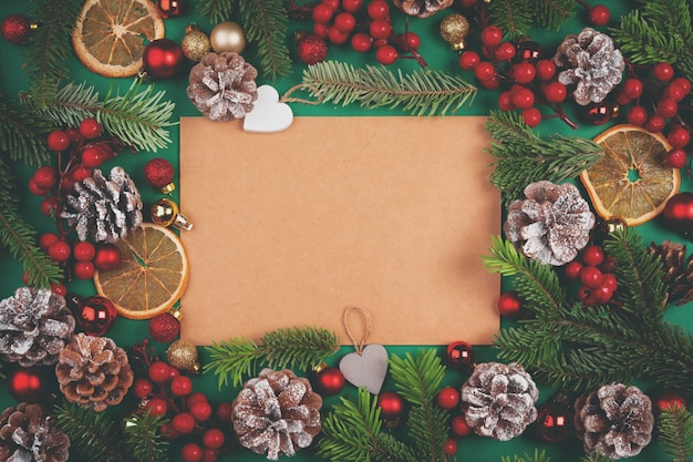 Christmas composition with empty sheet of  paper in the center