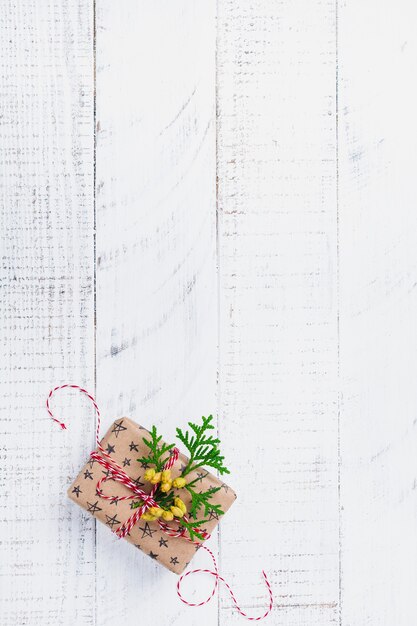 Christmas composition with gift box on wooden table. Top view with copy space.