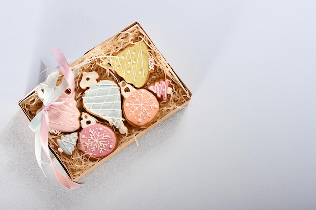 Christmas composition with ginger cookies in box on blue background