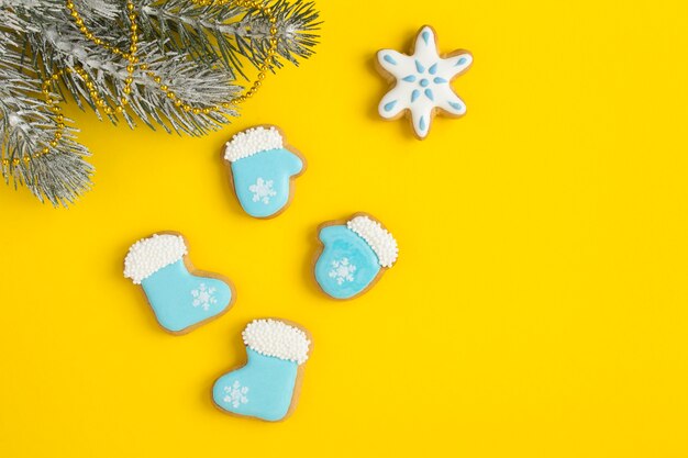 Christmas composition with gingerbread on the yellow background. Top view. Copy space.