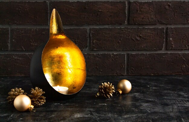 Christmas composition with an unusual candlestick candle golden cones  atmosphere of a mystery