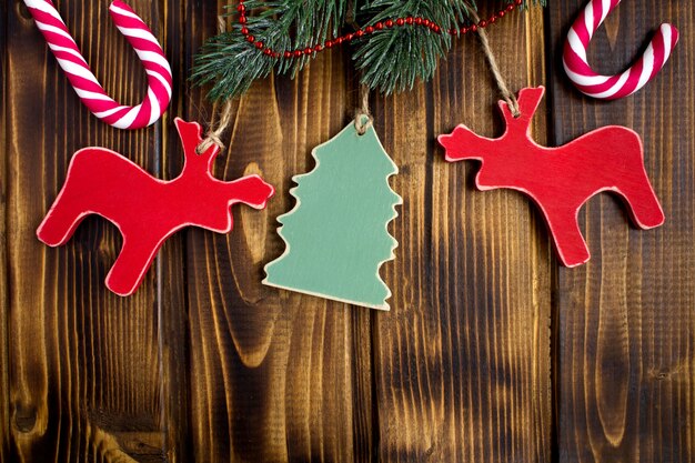 Christmas composition with wooden toys on the brown wooden  background.Top view.Copy space.