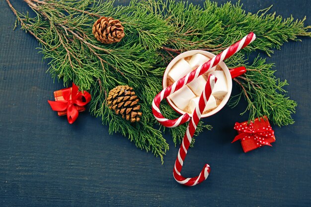 Christmas concept. Cup of hot chocolate with marshmallow and decorations on wooden table