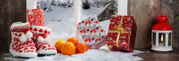 Christmas concept with slippers, oranges and gifts